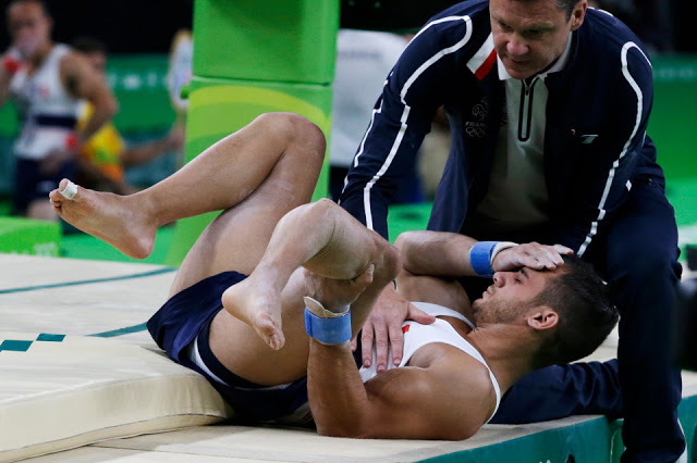 France's Samir Ait Said holds his leg after injuring it while performing on the vault during the artistic gymnastics men's qualification at the 2016 Summer Olympics in Rio de Janeiro, Brazil, Saturday, Aug. 6, 2016. (AP Photo/Rebecca Blackwell)