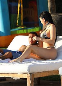 ***PREMIUM EXCLUSIVE RATES APPLY*** Kylie Jenner shows off her curves as Tyga holds onto her in the pool as they show PDA on vacation in Mexico. The happy couple were relaxing at Casa Aramara in Punta Mita Mexico as she leaned over to talk to him on some sun loungers while wearing a small black bikini and long black hair. Kylie had been spotting walking around the property in her bikini also. A playpen jumpy house was also spotted for Tyga's son, King Cairo.