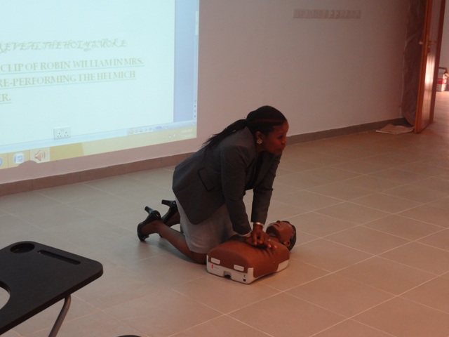 Participant practising CPR on a manikins
