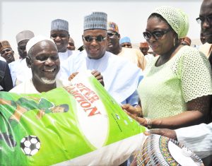 M.D. Dangote Foundation, Zouera Youssoufou, (Right) Presenting Food Items to one of The Beneficiary with A Bag  of Rice (Left) While Borno State Governor (Middle) Alhaji Kashim Shettima, At The Distribution of  Dangote Foundation Donate Foods Items for Ramadan to (IDP) Internal Displays People  of Bakkasi Camp in Maiduguri Borno State on 13-06-2016