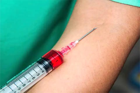 syringe going into arm