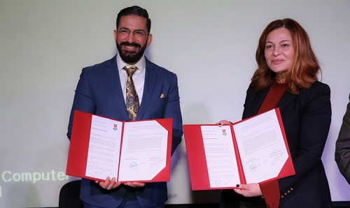 Dr-Ghada-Hanin-AUT-president-signing-the-agreement-with-Mr-Ramiz-Haddadin-Regional-Commercial-Head-Cambridge-Assessment-English-Photo-