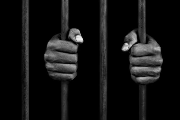 jail man holding bars