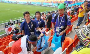 japanese fans clearing stands after match