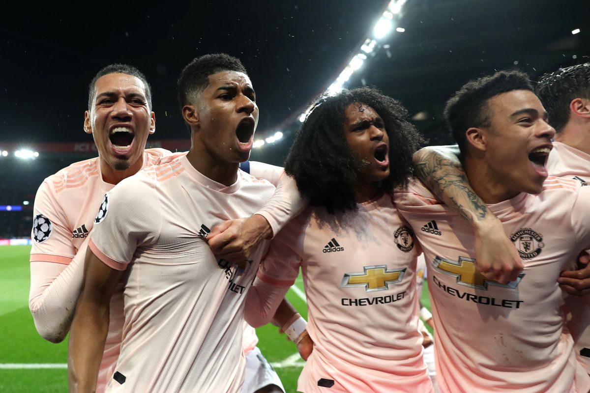 Manchester United players celebrate against PSG