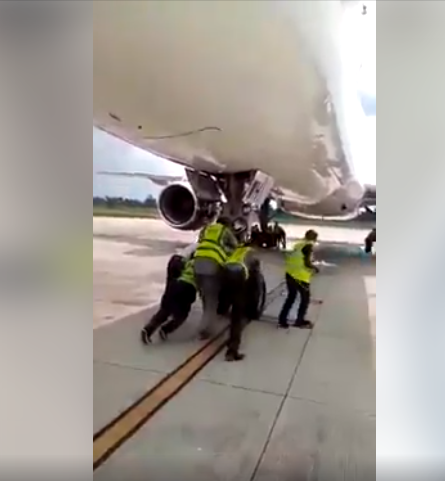UNBELIEVABLE! Nigerian Lady shocked as Airport Officials Push airplane (Video)